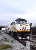 MP36PH-Q #107 powers a DeLand bound Sunrail Train into Sand Lake Road depot during the height of the morning rush hour.